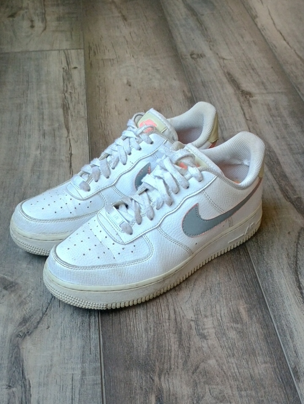 Nike White Sneakers with Light Gray Swoosh and Subtle Pink Accents